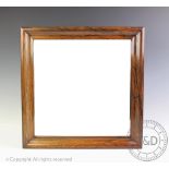 A 19th century rosewood wall mirror, the bevelled mirror plate set in a square ogee moulded frame,