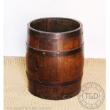 A coopered oak log barrel, with iron banding, 49.