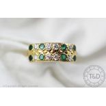 An emerald and diamond two row ring, designed as eight emeralds interspersed with eight diamonds,