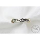 An 9ct gold diamond set eternity ring with 'knot' detail, designed as eight diamonds,