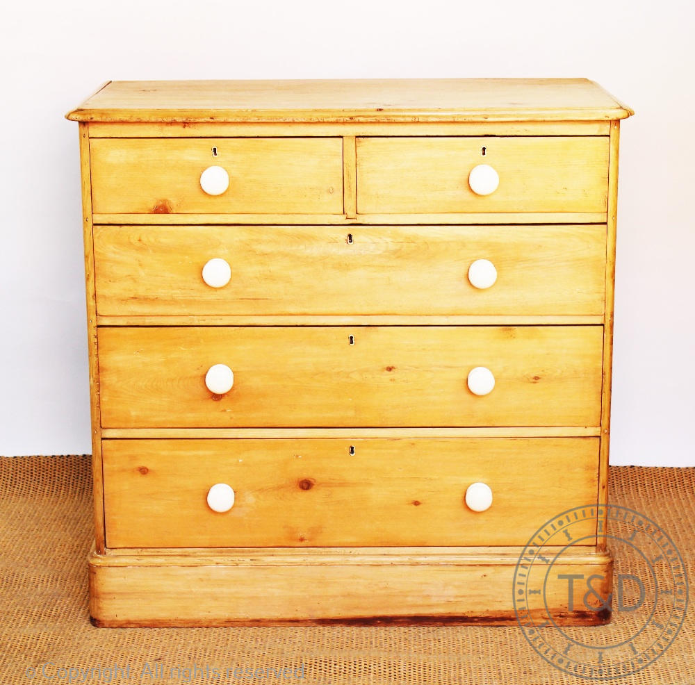 A pine chest, of two short and three long drawers, on plinth base,