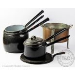 Five vintage black enamel saucepans,