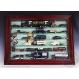 Three glass fronted cases containing Guinness related diecast vehicles by various makers,