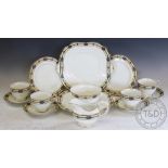 An Aynsley tea service, comprising: eleven tea cups and saucers, eleven cake plates,