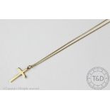 A 9ct yellow gold cross and chain, the plain polished cross with an attached fine chain,