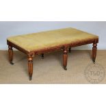 A William IV style oak foot stool of country house proportions, with patterned upholstery,