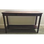 A reproduction mahogany two tier serving table (SIZE),