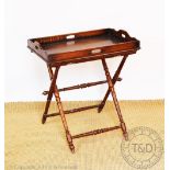 An Edwardian oak butlers tray and folding stand, the tray with four handles,