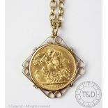 A George V 1912 full sovereign, within 9ct gold mould and attached chain stamped '9ct', 22.
