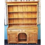 A Victorian and later pine country kitchen dresser, with three tier plate rack above two drawers,