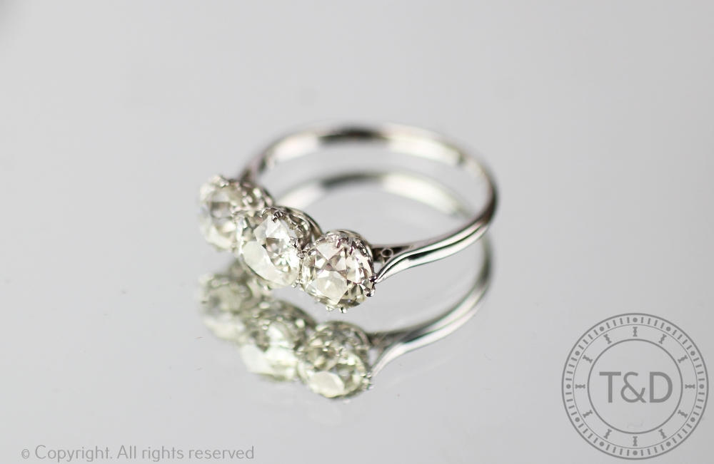 A three stone diamond ring, the three graduated,