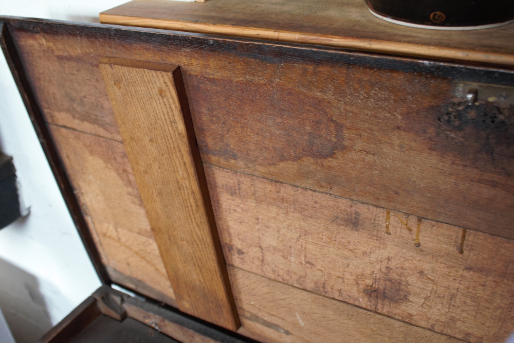 An 18th century oak coffer, with carved and panelled front, on stile legs, - Image 5 of 12