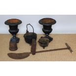 A pair of Victorian style cast iron urns, each 37cm high, together with a wrought iron peat cutter,