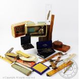 An assortment of drawing and measuring instruments, to include rulers, tape measures,