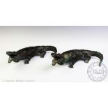 A pair of bronze crocodiles, each modelled with open mouth,