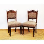 A set of four Victorian carved walnut dining chairs, with patterned upholstery,