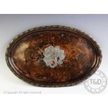 A Hugh Wallis planished copper oval tray, with central foliate motif and ribboned border,