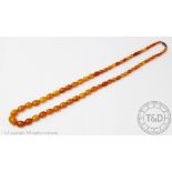 A single strand, graduated butterscotch amber bead necklace, gross weight 30.