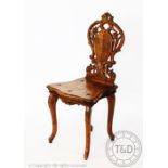 An early 20th century Black Forest musical chair decorated with edelweiss,