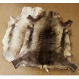 Two reindeer hide rugs, one 133cm long,