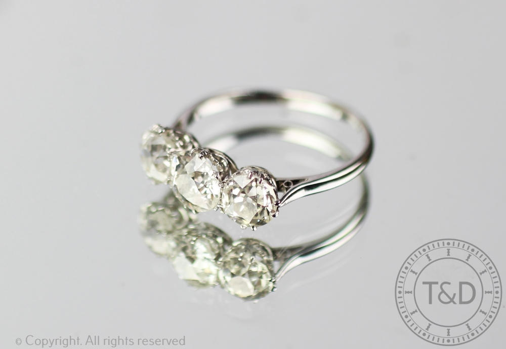 A three stone diamond ring, the three graduated, - Image 2 of 3
