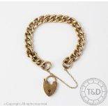 A 9ct yellow gold curblink bracelet, with heart shaped padlock clasp,