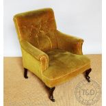 An early 20th century salon tub type chair, with button back green upholstery, on cabriole legs,