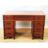 A Chinese carved oak pedestal desk, with an arrangement of nine drawers, on scroll legs, 76.