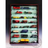 Two glass fronted cases containing approximately forty five unboxed diecast vehicles,