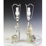 A pair of Lladro figural glazed pottery lamp bases with shades, one modelled as a young man,