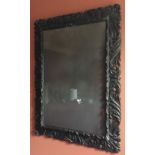 A late 19th / early 20th century Florentine style carved pine and ebonised acanthus leaf frame and