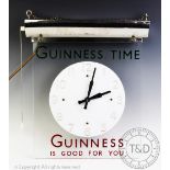 A Guinness advertising clock circa 1950s, in acrylic with chrome lamp holder,