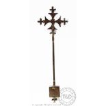 An Ethiopian iron hand cross, the top engraved with masks and scrolling detailing,