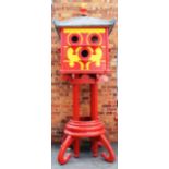 A large modern Chinese style red and yellow painted dovecote,