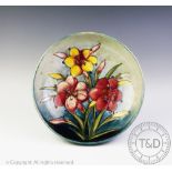 A Moorcroft bowl, circa 1930, decorated in the African lily pattern against a washed blue ground,