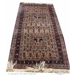 A Caucasian wool rug, worked with two panels decorated with deer,