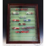A glass fronted case containing ten diecast fire engines and a box containing a quantity of empty