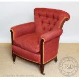 An Edwardian salon chair, button back upholstery, on tapered legs,