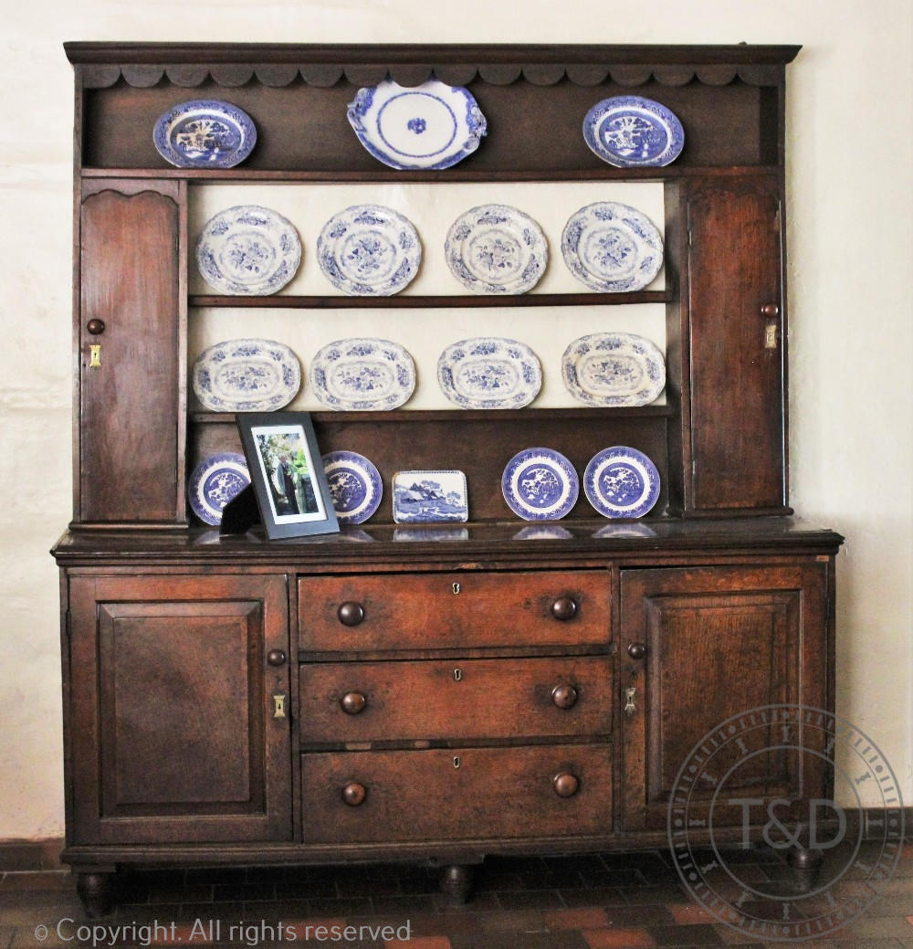 An 18th century oak high back dresser, Mid Wales, with scalloped cornice,