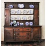 An 18th century oak high back dresser, Mid Wales, with scalloped cornice,