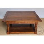 A modern oak coffee table of country house proportions, with four plank top, on turned legs,