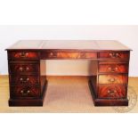A Reprodux mahogany partners desk, the leather inset top with three drawers and faux drawers,