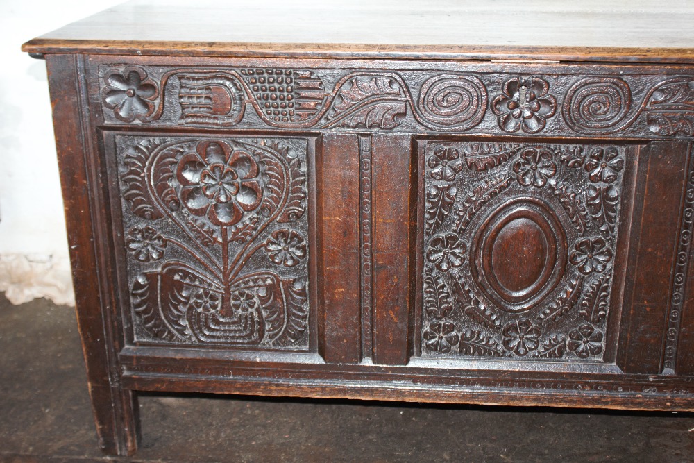 An 18th century oak coffer, with carved and panelled front, on stile legs, - Image 9 of 12