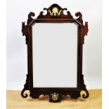 A George III style mahogany wall mirror, with brass mounts and scroll frame,