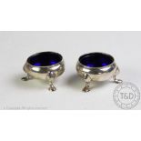 A pair of George III silver salts, London, each of cauldron from with blue glass liners,