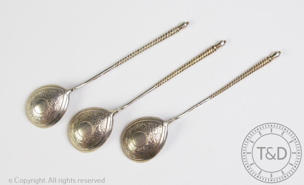 A set of three Russian silver spoons, 19th century, with twisted stems and urn finials,