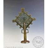 An Ethiopian processional cross, on square form, with pierced and engraved detailing,