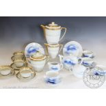 A Limoges tea service, 20th century, comprising: twelve tea cups and saucers, a tea pot, a sucrier,