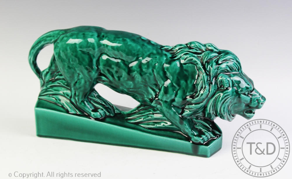 A French majolica model of a lion, early 20th century, modelled on a plinth base,