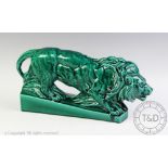 A French majolica model of a lion, early 20th century, modelled on a plinth base,